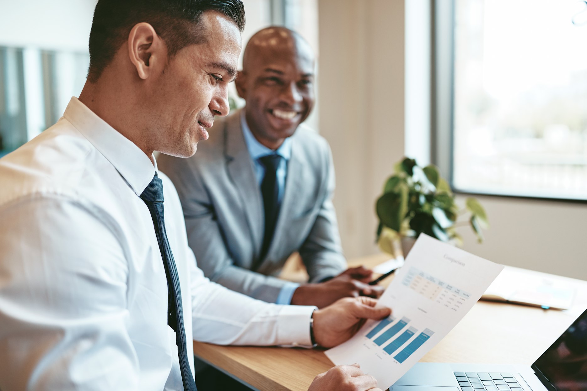 Business professionals reviewing financial reports on deferred revenue and expenses in the UAE for accounting and tax planning.