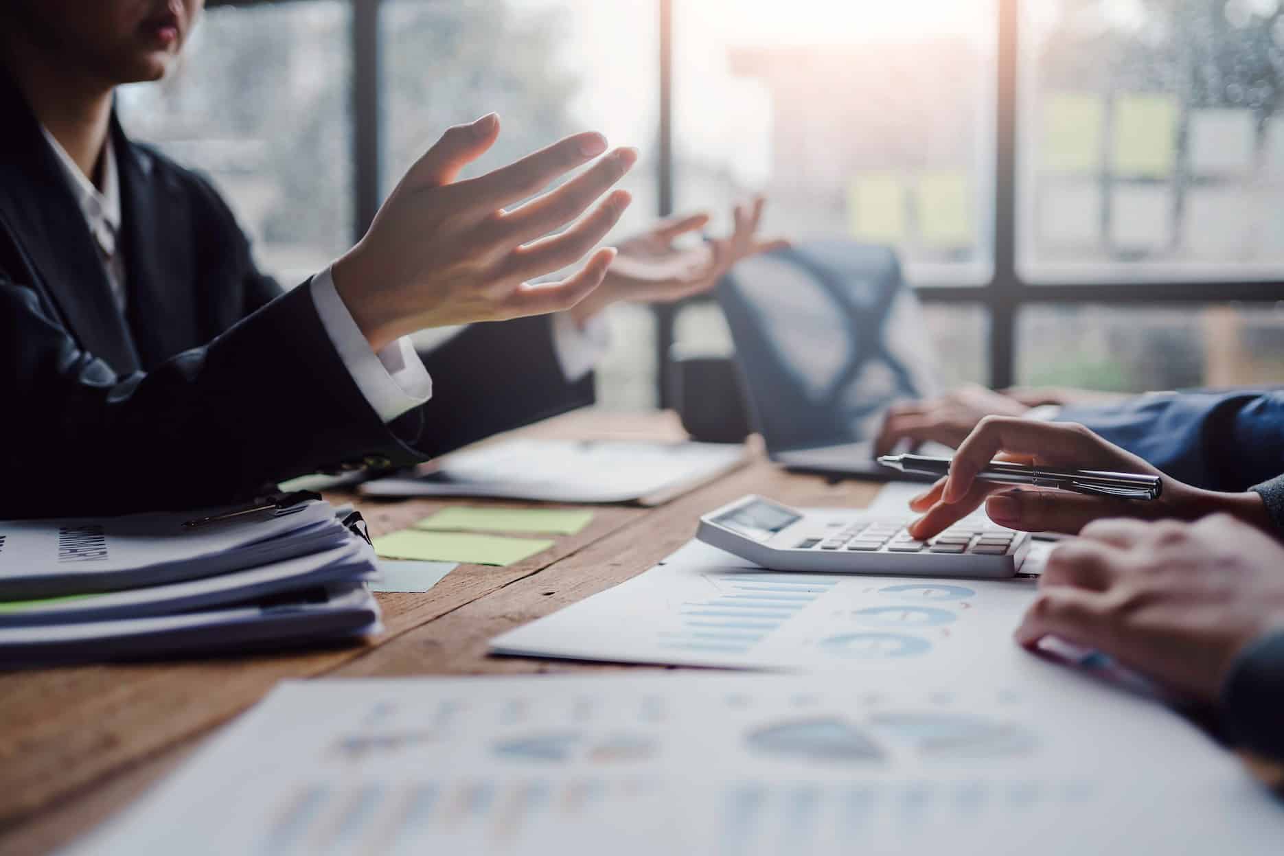 Business advisers reviewing financial documents and market-value evidence for connected person payments in UAE corporate tax.