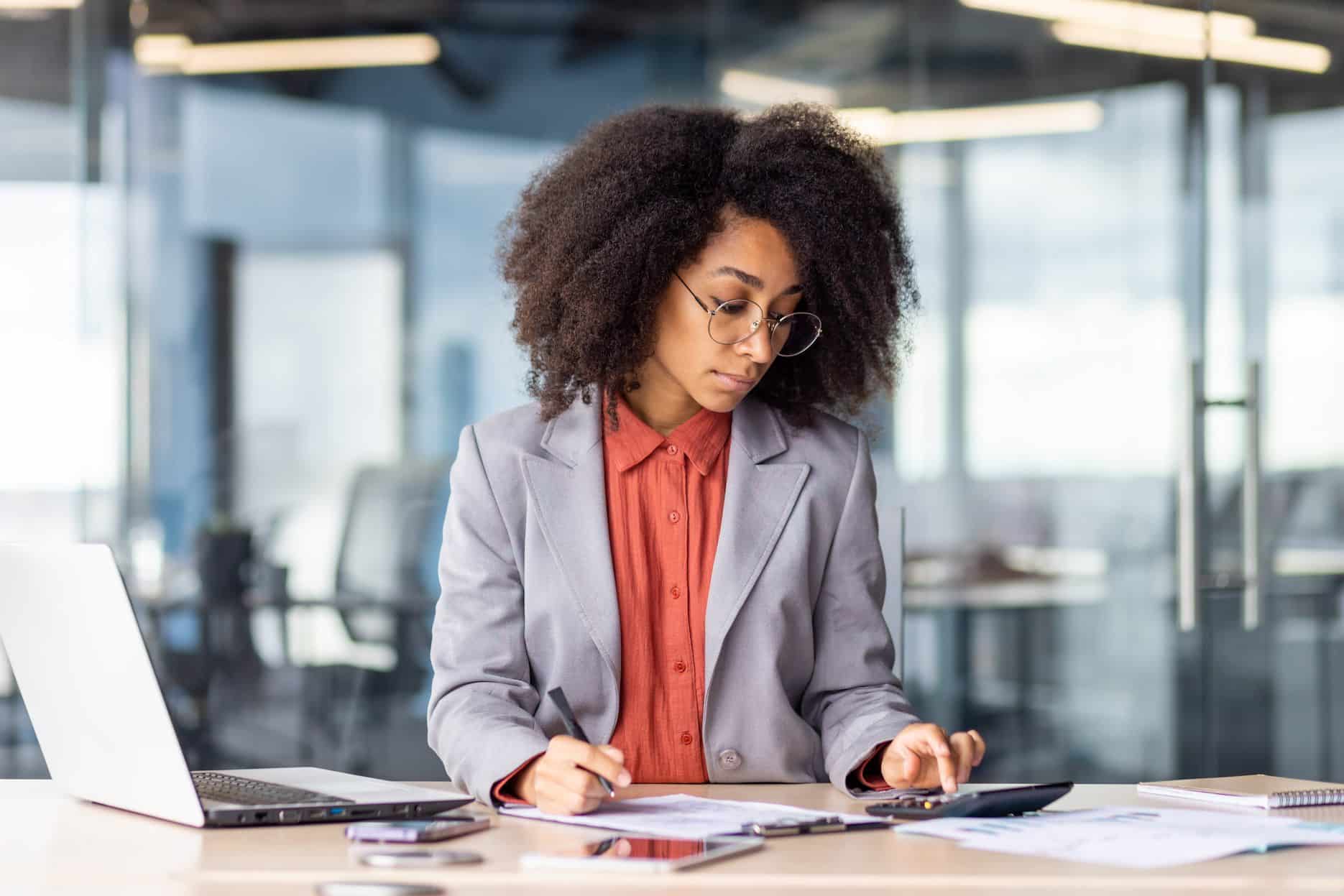 Finance professional checking invoices and expense records for non-deductible business costs in the UAE.