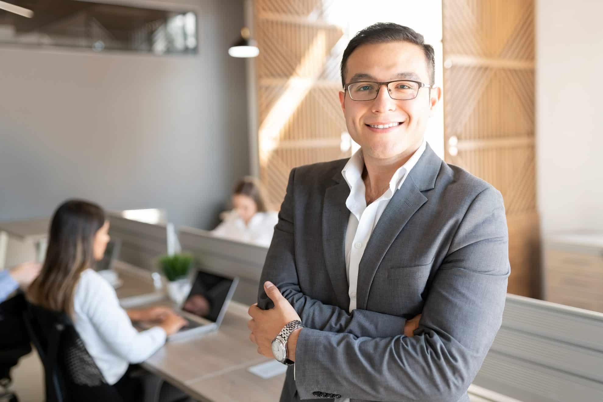 Confident UAE business owner in modern office, ready with required documents for corporate tax registration in the UAE.