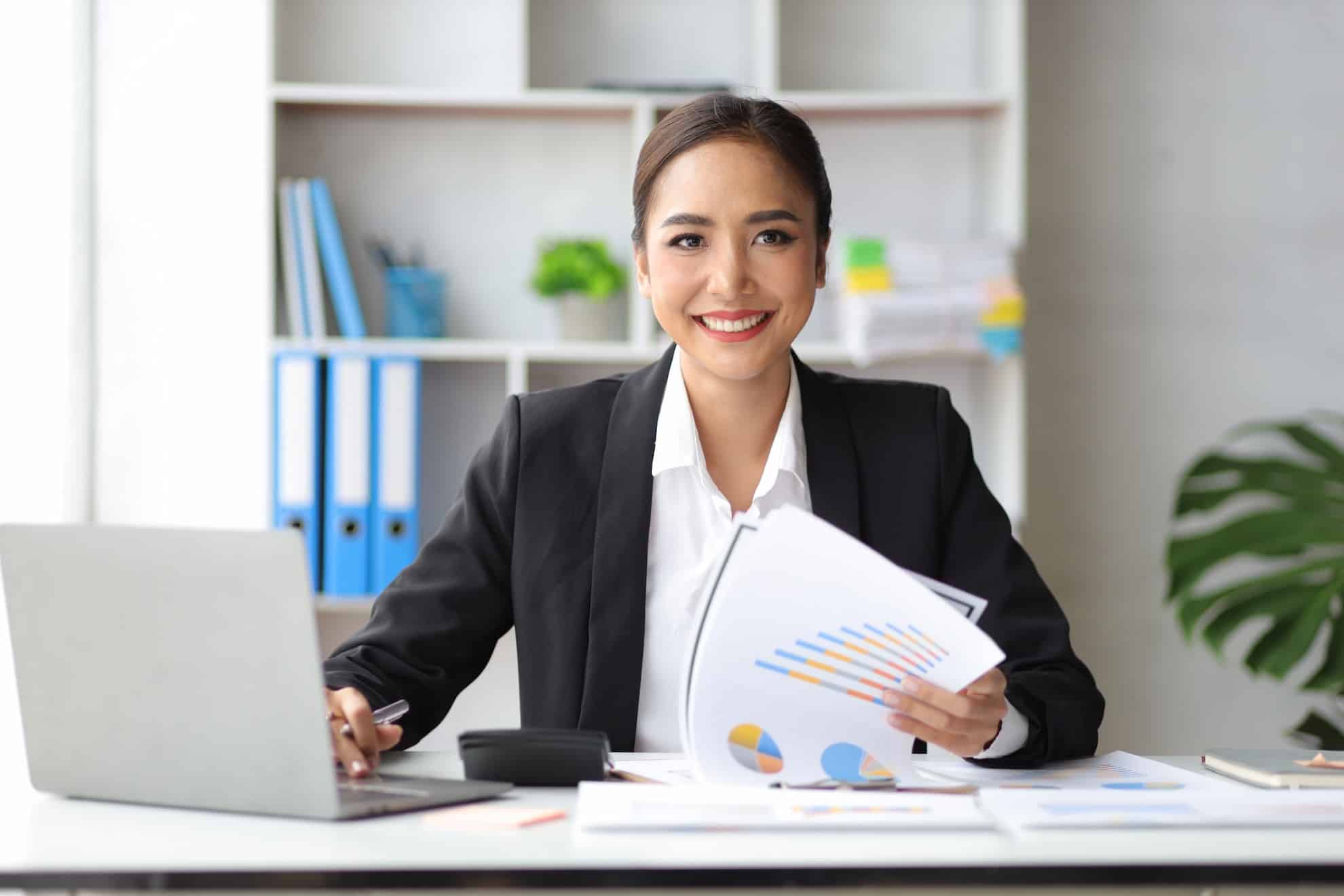 Businesswoman reviewing tax charts in UAE office for small business relief planning.