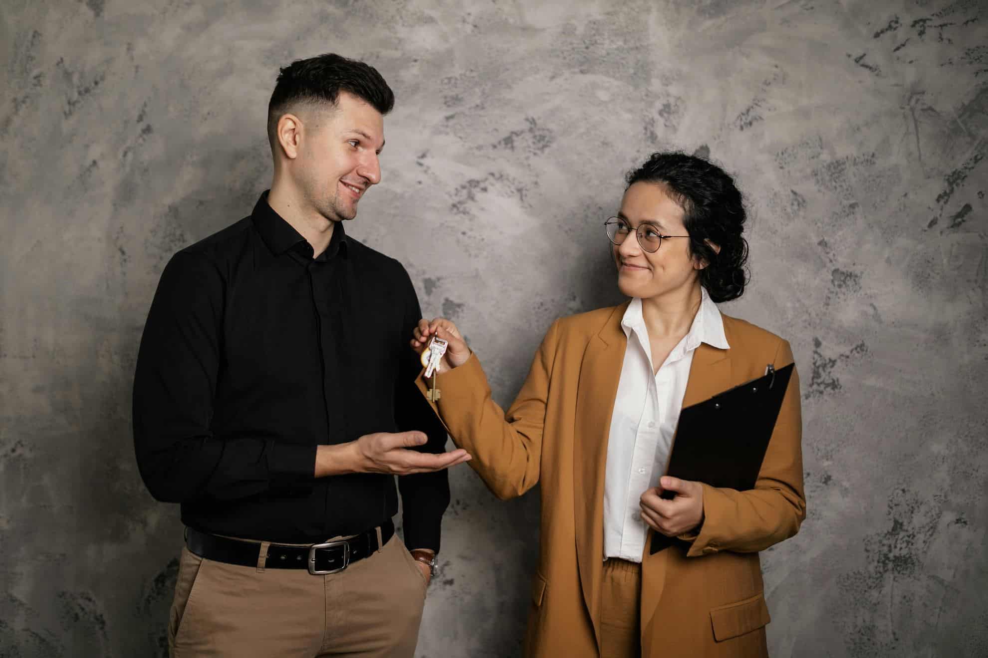 Real estate agent handing keys to a new commercial tenant, symbolizing property transfer and VAT compliance in UAE commercial property transactions.